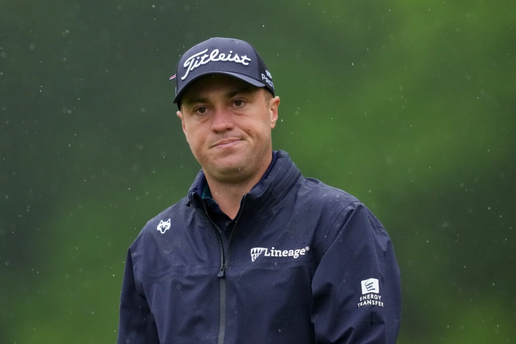 Justin Thomas walks in the rain in round two of The Memorial Tournament