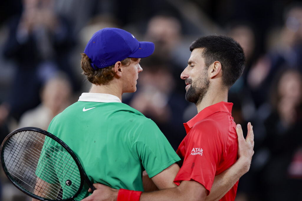 Jannik Sinner and Novak Djokovic embrace after their match at the 2025 French Open