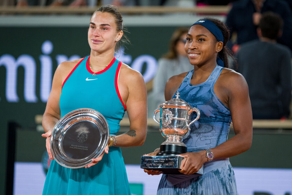 Coco Gauff and Aryna Sabalenka pose with the trophies after their 2025 French Open final