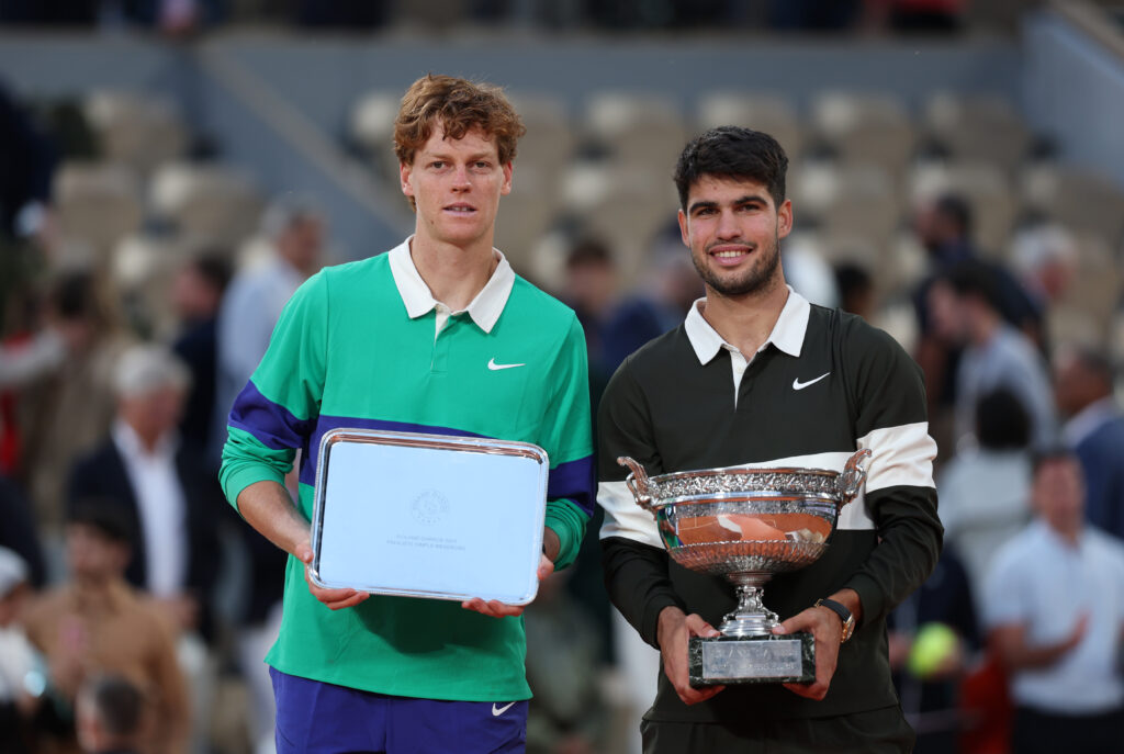 Carlos Alcaraz of Spain poses for a photo with the Coupe des Mousquetaires trophy alongside runner-up Jannik Sinner of Italy following his victory in the Men’s Singles Final match on Day Fifteen of the 2025 French Open at Roland Garros.