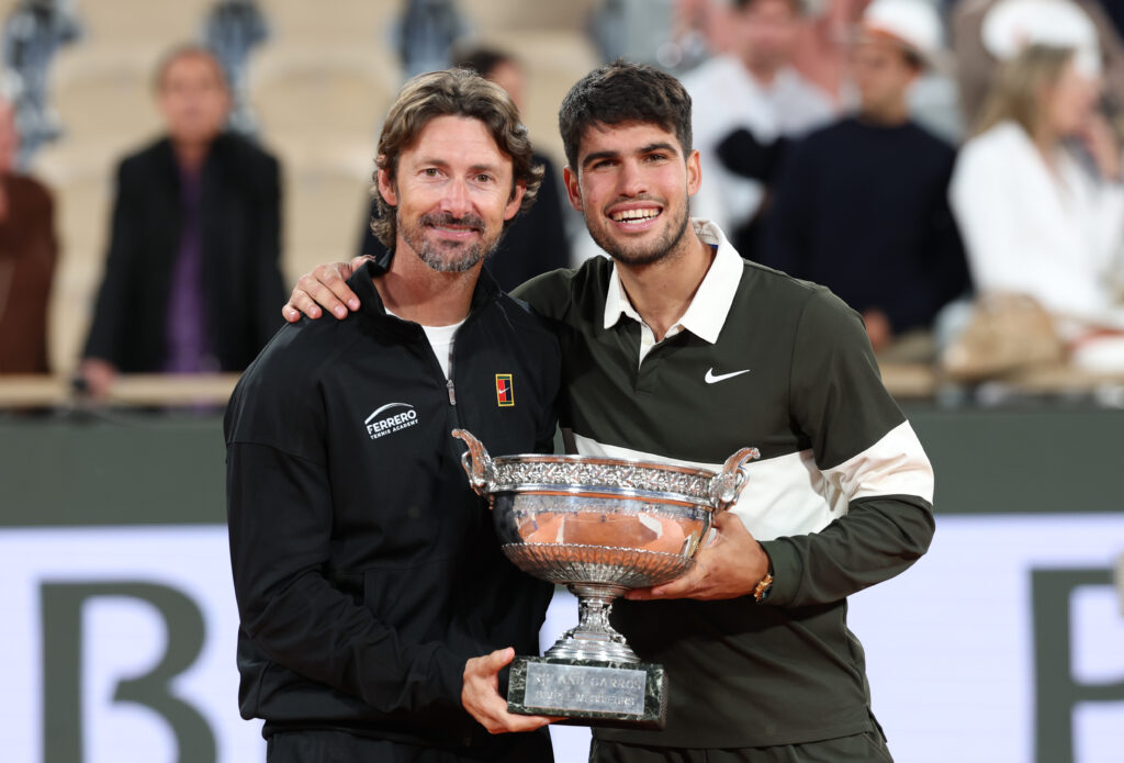 Carlos Alcaraz of Spain poses for a photo with his coach Juan Carlos Ferrero following his victory over Jannik Sinner of Italy in the Men's Singles Final on Day Fifteen of the 2025 French Open at Roland Garros.