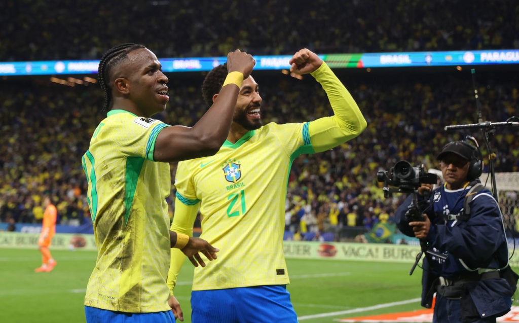 Vinicius Junior and Matheus Cunha of Brazil celebrate after scoring vs Paraguay.