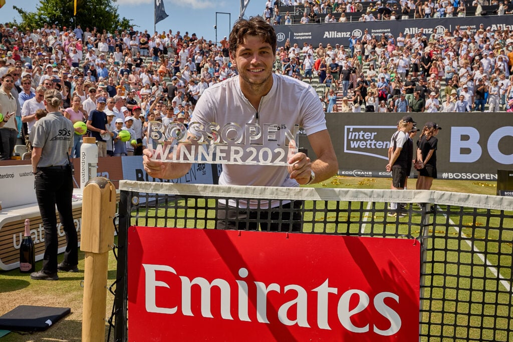 Taylor Fritz of United States poses with his trophy for the singles Champion at the Emirates net sign after winning the final against Alexander Zverev of Germany during Day 7 of the Boss Open at Tennisclub Weissenhof.