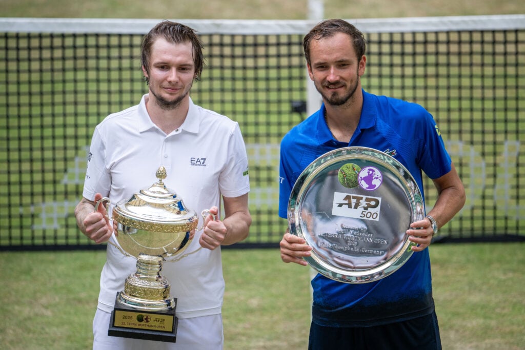 Alexander Bublik and Daniil Medvedev holding their trophies after the 2025 Halle Open final.