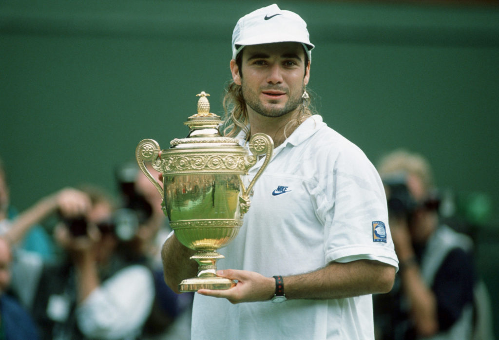 Andre Agassi poses with the trophy after beating Goran Ivanisevic in the 1992 final