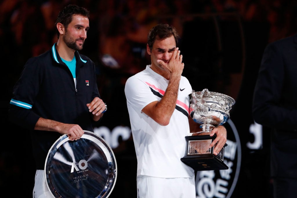 Marin Cilic and Roger Federer hold their trophies after the 2018 Australian Open final