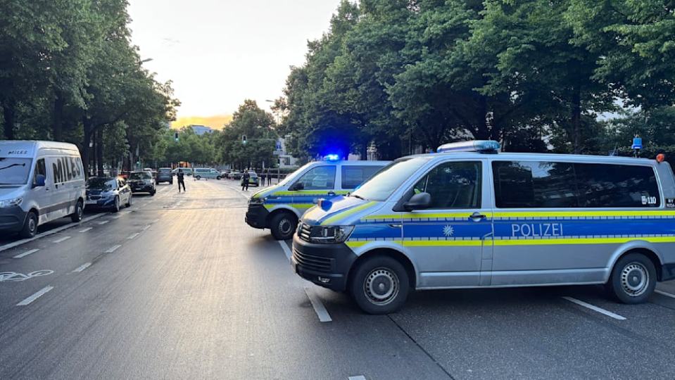 Two German police vans parked on a city street.