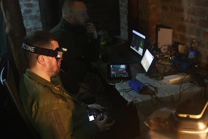 Red (with goggles), an Achilles unit pilot, controls the flight of a kamikaze drone over Russian positions on the Kharkiv front on May 13.