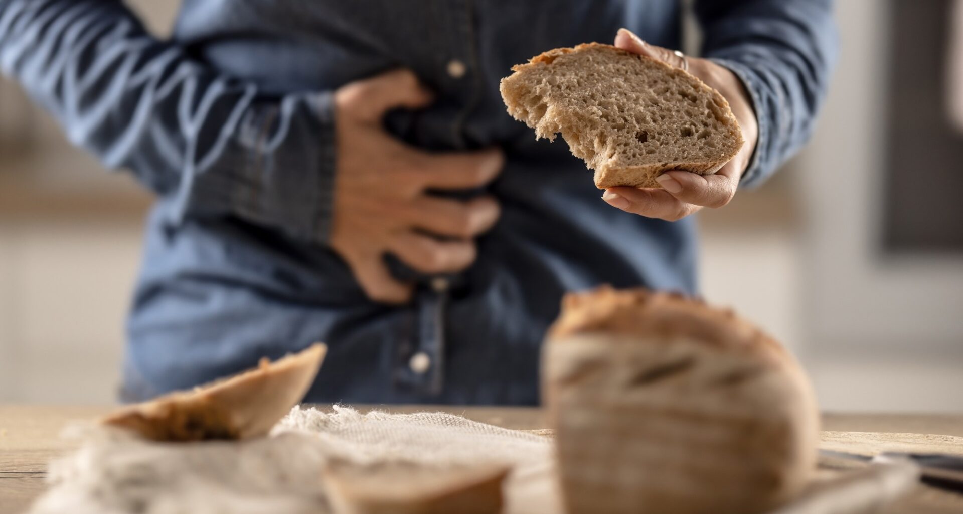 A young celiac woman suffers from abdominal pain after eating fresh bread