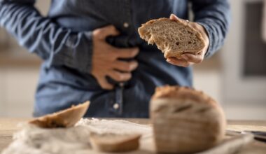 A young celiac woman suffers from abdominal pain after eating fresh bread
