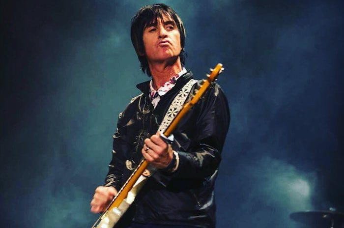Johnny Marr playing the guitar on tour
