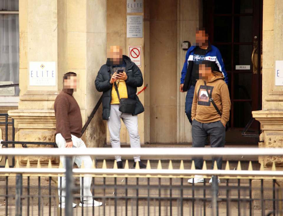 Men standing outside a hotel.