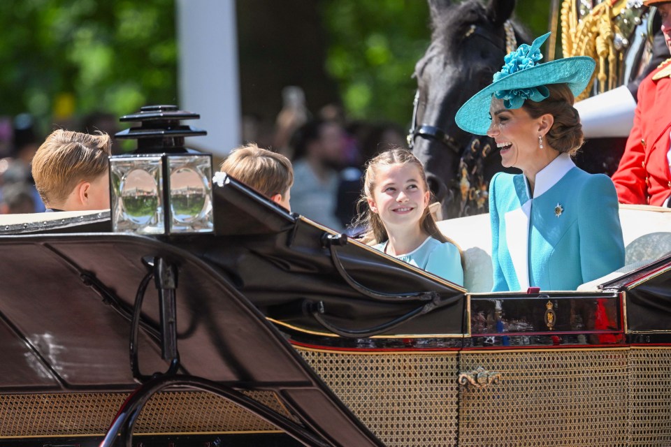 The Prince and Princess of Wales with their three children in a carriage.