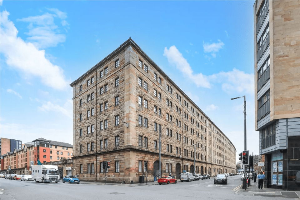 Large stone building on a city street.