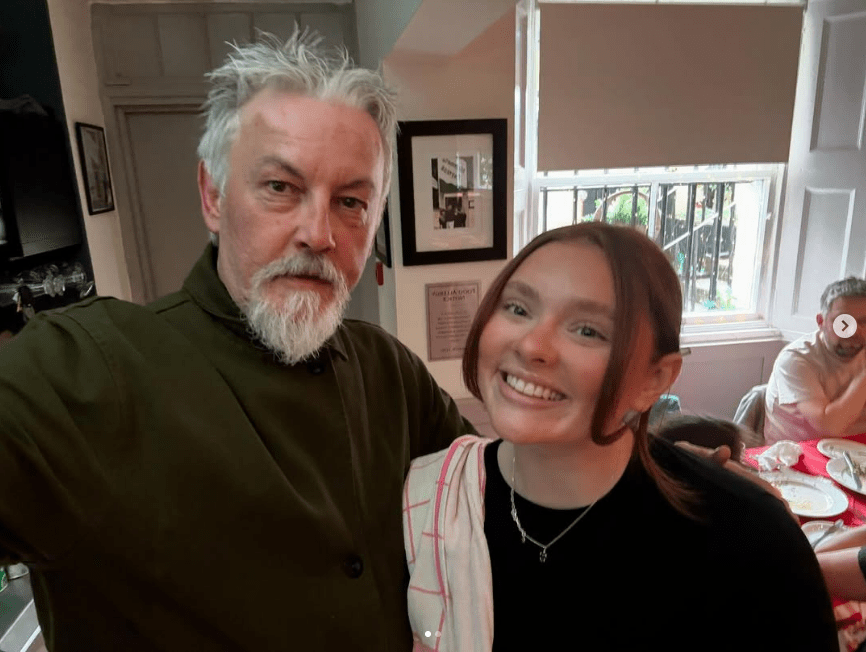 Photo of a man and a woman smiling for a selfie.