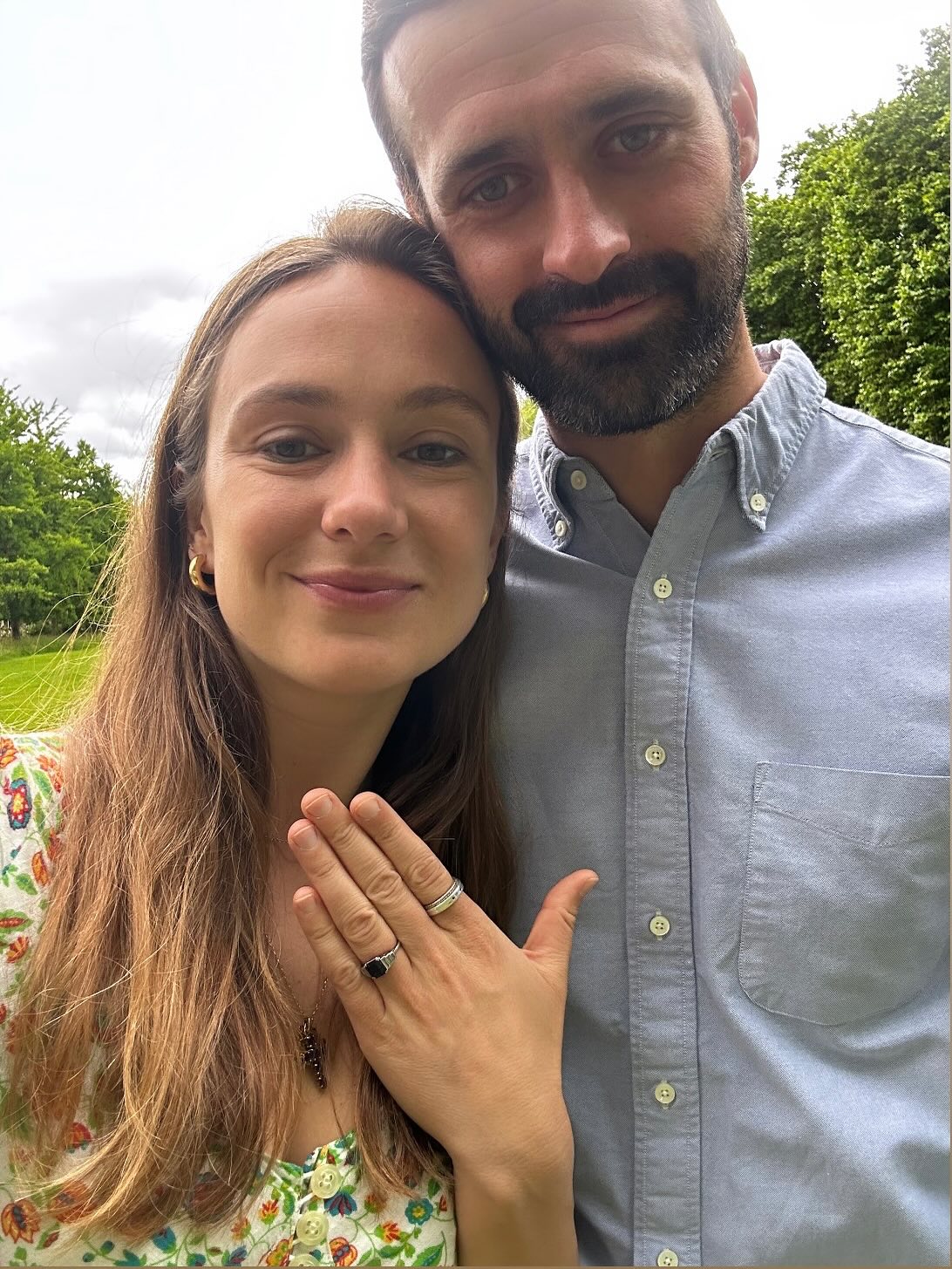 Lady Marina Windsor and her fiancé Nico Macauley showing her engagement ring and smiling