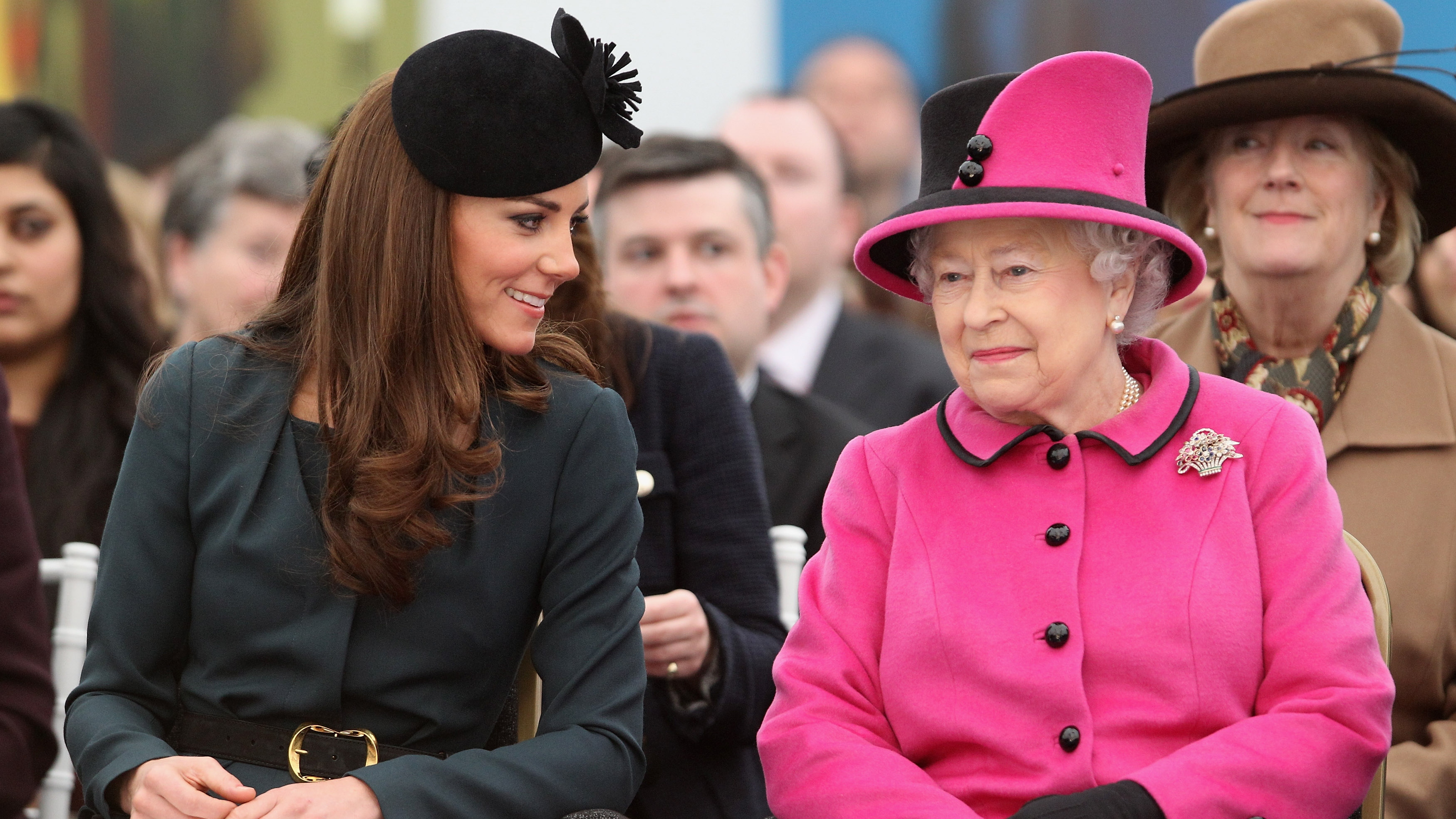 Queen Elizabeth II (R) and Catherine, Princess of Wales (L) watch a fashion show at De Montfort University on March 8, 2012 in Leicester