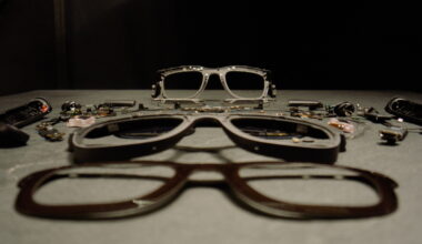 The Meta Orion AR glasses disassembled and sitting on top of a gray table