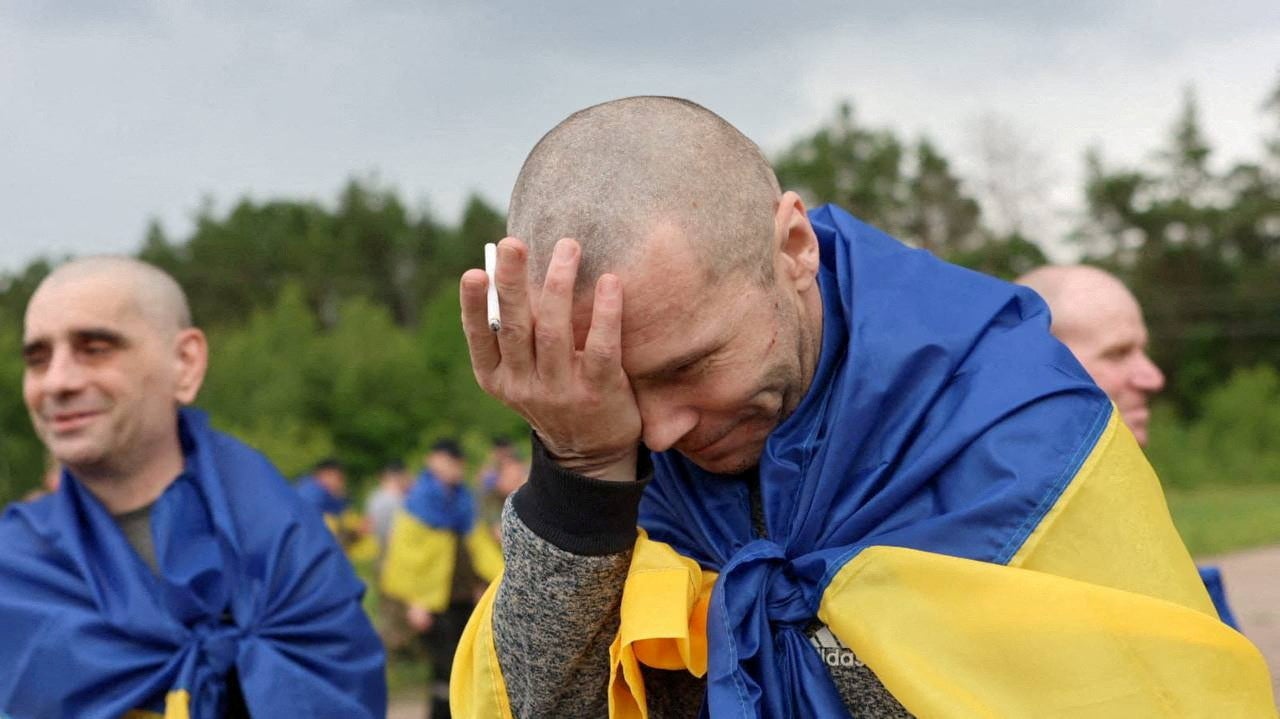 A Ukrainian prisoner of war (POW) reacts after a swap