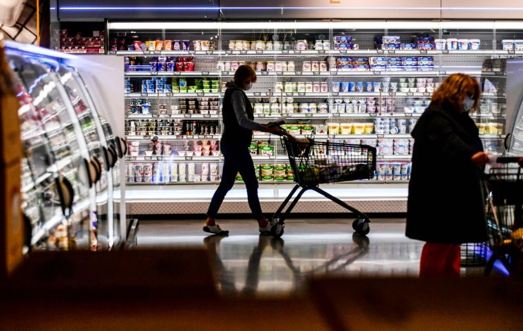 (FILES) This file photo taken on April 29, 2020 shows a customer pushing a shopping cart past the shelves during purchases at a supermarket in Duesseldorf, western Germany, on April 29, 2020. - A surge in eurozone consumer prices, propelled even higher by Russia's invasion of Ukraine, is "very close" to reaching its peak, European Central Bank vice-president Luis de Guindos said on April 28, 2022. (Photo by Ina FASSBENDER / AFP) (Photo by INA FASSBENDER/AFP via Getty Images)