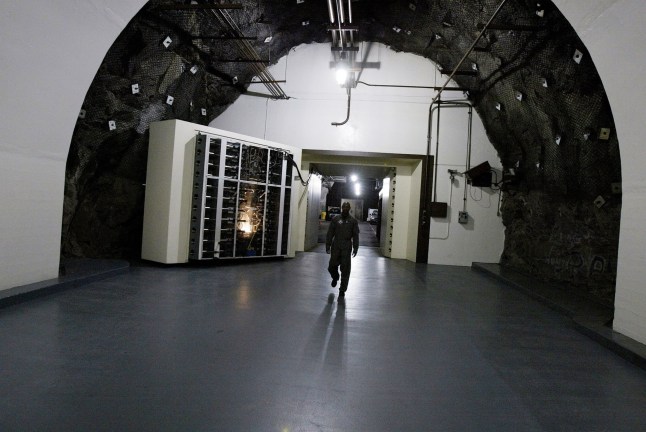 COLORADO SPRINGS, CO - MAY 11: At the second interior entrance to the Cheyenne Mountain Complex headquarters for NORAD a military officer exits the administrative area May 11, 2004 in Colorado Springs, Colorado. Constructed during the Cold War period in 1958, NORAD (North American Aerospace Command) was responsible for external air, missile and space defense. Since September 11, 2001, it now watches 7,000 aircraft per day within the US NORAD covers each aircraft's flight pattern including contingencies for the US President's flights and landings. NORAD coordinates with civilian authorities and works with the Pentagon, federal, state and local authorities. Canadian military officials make up 10-15 percent of NORAD's 326 total staff. NORAD works with Department of Homeland Security (DHS) but is not part of DHS. The personnel work at 7,000 feet inside a granite mountain. Two 25-ton security doors seal the inside offices from any type of attack. NORAD has a self sufficient survival system with independent water and air supplies. (Photo by Robert Nickelsberg/Getty Images)