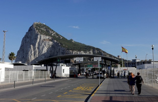 FILE PHOTO: Pedestrians and drivers cross the border from Spain to Gibraltar, in front of the Rock of Gibraltar, in La Linea de la Concepcion, southern Spain, June 4, 2024. REUTERS/Jon Nazca/File Photo