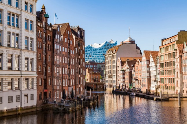 A view of a canal and canalside buildings in Hamburg, Germany on a sunny day