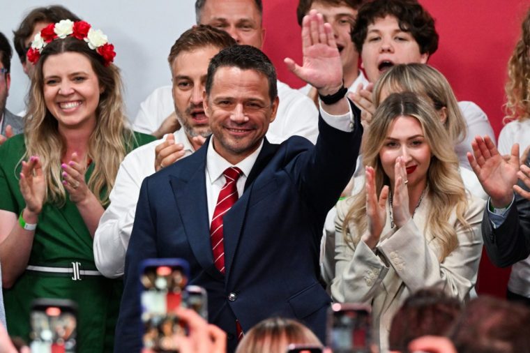 WARSAW, POLAND - JUNE 01: The Mayor of Warsaw and the Civic Coalition (KO) presidential candidate, Rafal Trzaskowski and his wife Malgorzata celebrate the exit poll results during the runoff of the presidential election on June 01, 2025 in Warsaw, Poland. Today's presidential runoff election is a closely contested race between Rafal Trzaskowski, the liberal mayor of Warsaw who is supported by Prime Minister Donald Tusk, and Karol Nawrocki of the Law and Justice Party (PiS), which has held the presidency since 2015. The election is seen as a test of whether the government, with its centrist parliamentary coalition, can overcome the right-wing populism embodied by PiS. Exits polls shows Trzaskowski winning 50.3% to right-wing contender Karol Nawrocki???s 49.7%. (Photo by Omar Marques/Getty Images)