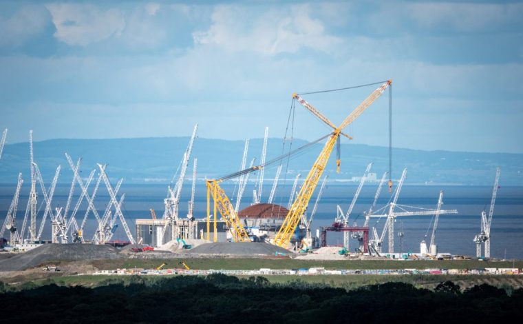 BRIDGWATER, ENGLAND - SEPTEMBER 27: Cranes surround one of the two reactors being constructed at Hinkley Point C on September 27, 2024 in Bridgwater, England. The first new nuclear power station to be built in the UK in almost 30 years; Hinkley Point C (HPC) in Somerset will provide low-carbon electricity for around 6 million homes, create thousands of jobs and bring lasting benefits to the UK economy. Hinkley Point C will make a major contribution to the UK???s move to reduce carbon emissions. The electricity generated by its two EPR reactors will offset 9 million tonnes of carbon dioxide emissions a year, or 600 million tonnes over its 60-year lifespan. However, French utility EDF has recently warned the costs of the Hinkley Point C nuclear power plant, could rise more than 20% higher than its estimate last year. (Photo by Anna Barclay/Getty Images)