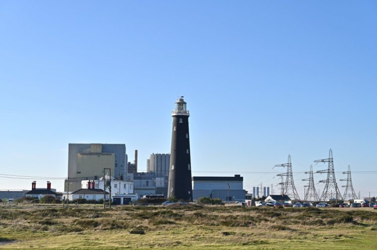 DUNGENESS, ENGLAND - FEBRUARY 2: A general view of the Dungeness B nuclear power station and the Old Lighthouse, a historic grade 11 listed building on February 2, 2025 in Dungeness, England. (Photo by John Keeble/Getty Images)