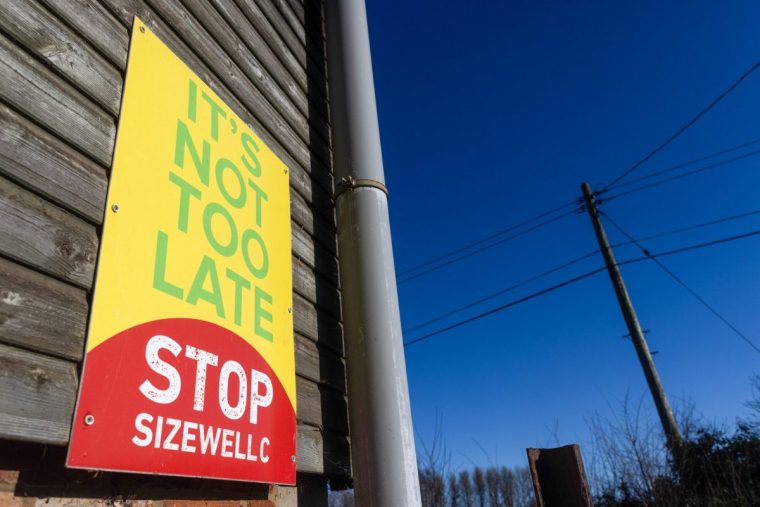 A sign protesting against the new Sizewell C nuclear power station, operated by Electricite de France SA (EDF), in Sizewell, UK, on Friday, Jan. 26, 2024. The UK government will invest an additional ??1.3 billion ($1.7 billion) to build the??Sizewell??C nuclear plant to try and entice private investors to back the project. Photographer: Chris Ratcliffe/Bloomberg via Getty Images