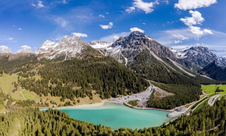 Idyllic view of the turquoise colored Iselsee lake in Arosa in the alps in Canton Graub??nden in Switzerland on a sunny day