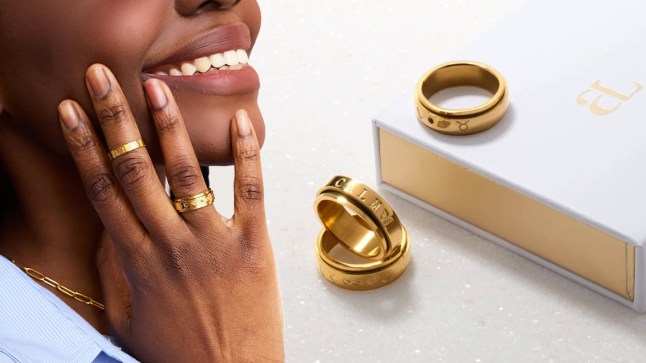 Female poses with her hand to her face, showing off gold jewellery. Seperatley three gold rings are together on a white background.