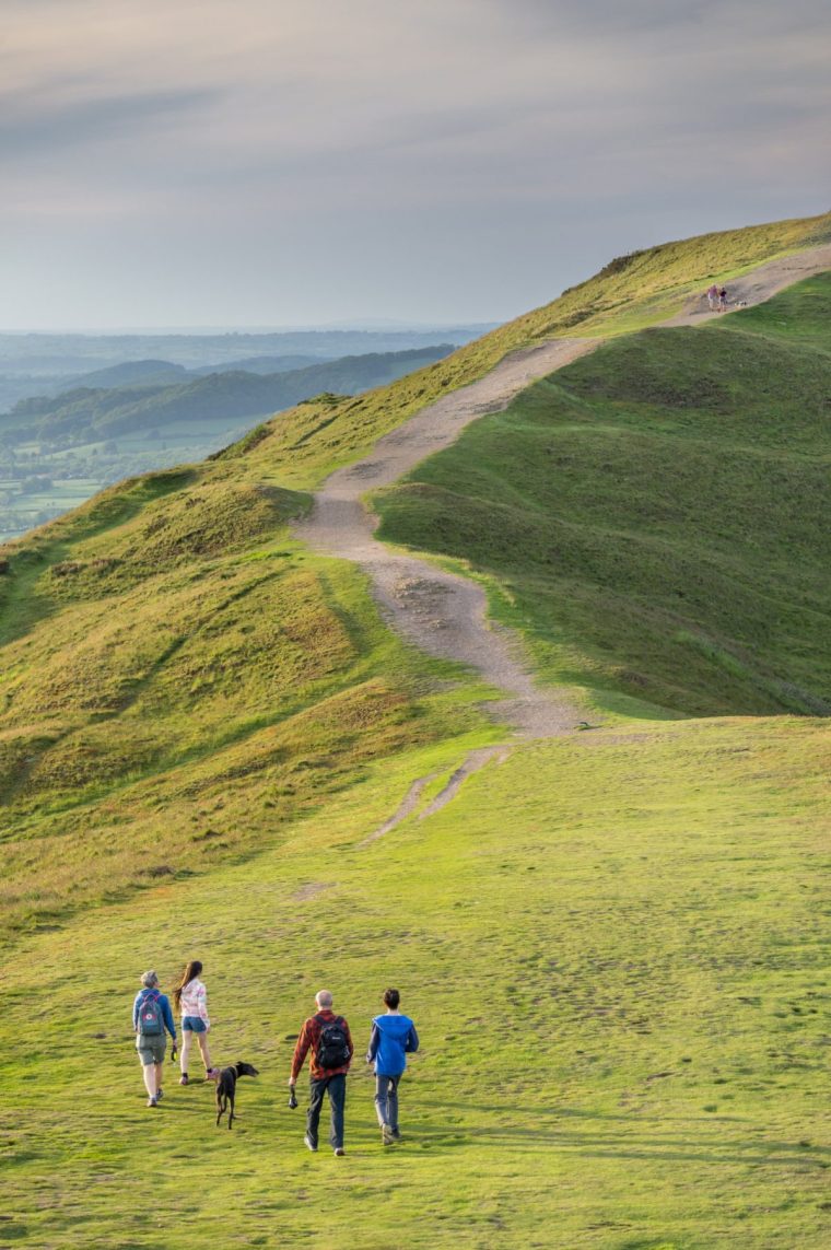 Malvern Worcestershire,England-June 01 2021:Visitors to this popular beauty spot,enjoy exercising and taking in the beautiful views from the various hilltops, around the 8 mile long range of hills.