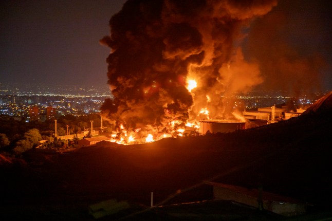 TEHRAN, IRAN - JUNE 15: Fire and smoke rise into the sky after an Israeli attack on the Shahran oil depot on June 15, 2025 in Tehran, Iran. Iran's foreign minister said the country would respond decisively and proportionally to a wave of attacks that Israel launched beginning in the early hours of June 13. The attacks targeted multiple military, scientific and residential locations, as well as senior government officials. (Photo by Stringer/Getty Images)