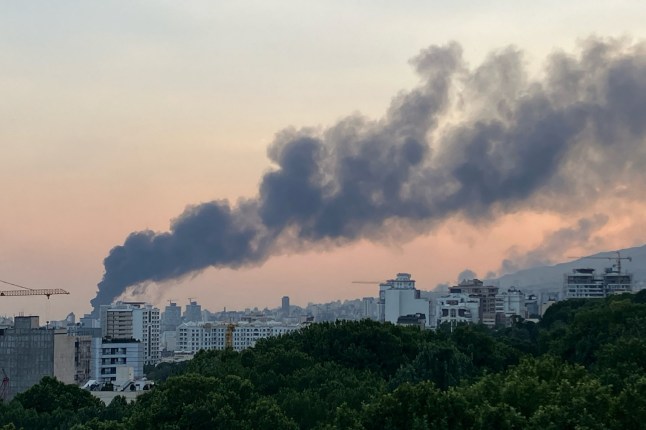 TOPSHOT - Smoke billows from an explosion at the Islamic Republic of Iran Broadcasting (IRIB) building in Tehran on June 16, 2025. The IRIB building was struck in an Israeli attack on June 16, cutting live coverage immediately. The blast occurred as the presenter was live on TV lambasting Israel before she was seen leaving the live broadcast, Iranian media reported, sharing a video of the incident. (Photo by AFP) (Photo by -/AFP via Getty Images) ***BESTPIX***