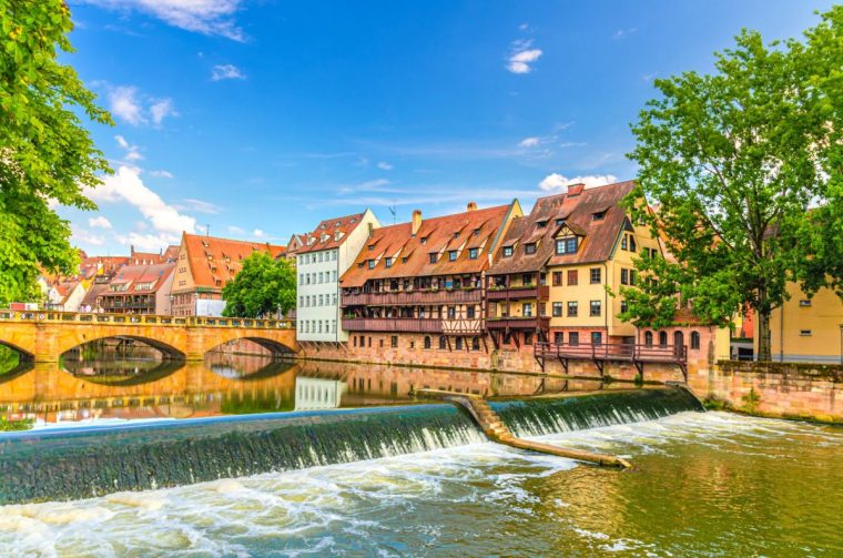 Max Bridge Maxbrucke, Medieval buildings on Pegnitz river bank and Pegnitzwehr waterfall damb in Old town Nuremberg city historical center, Middle Franconia region, Bavaria state, Germany