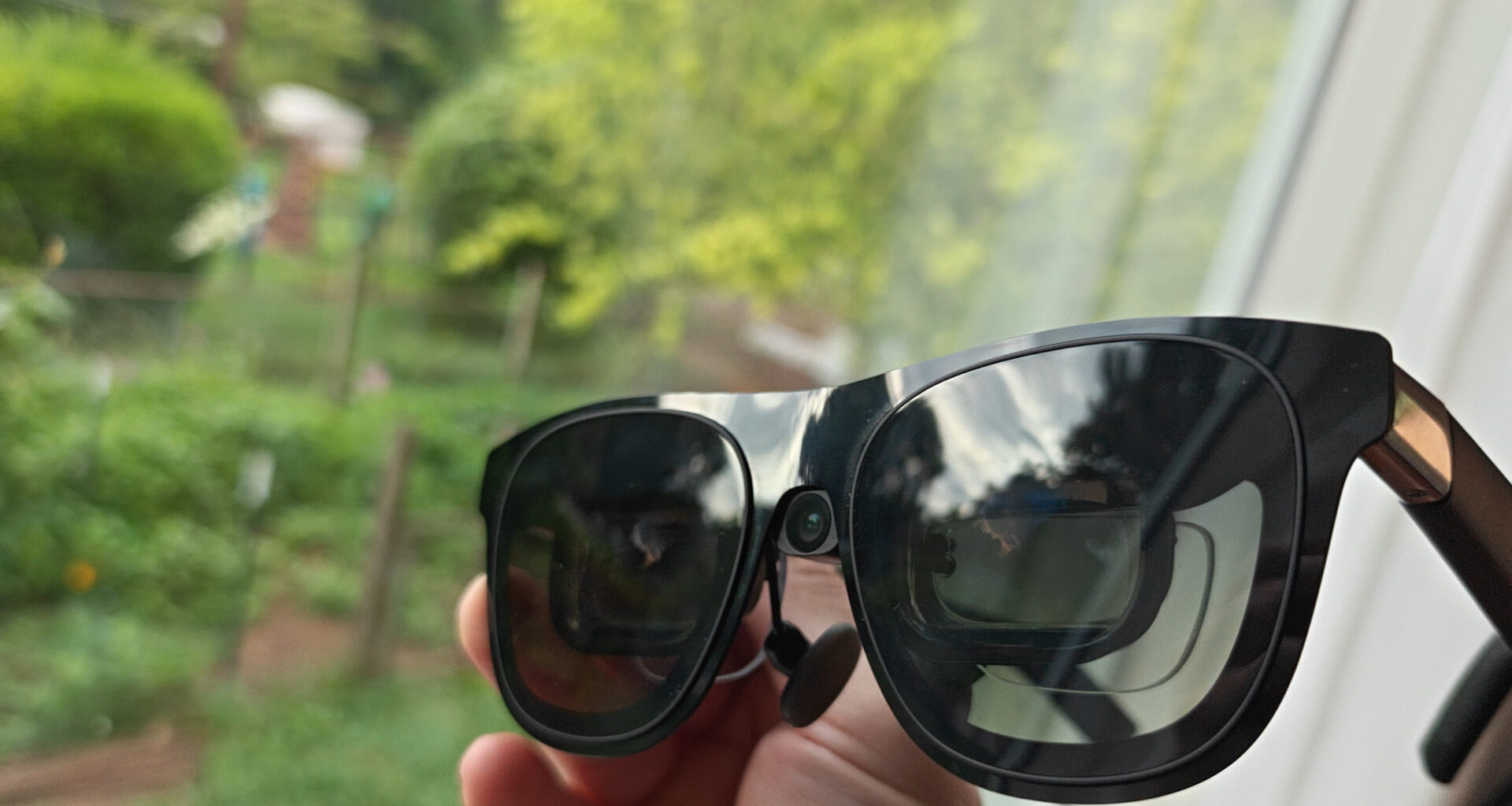 A pair of Xreal One smart glasses outfitted with an Xreal Eye camera and a set of HonsVR prescription lenses