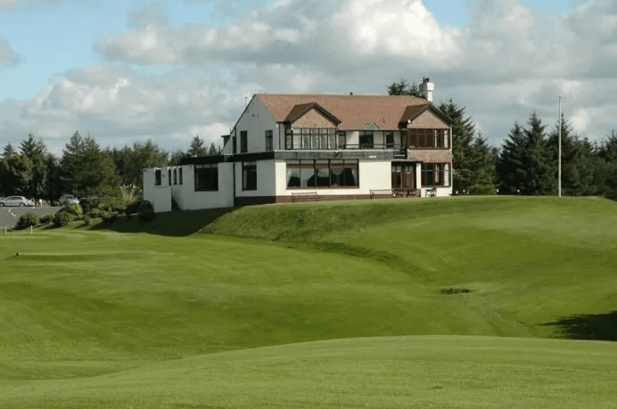 Golf clubhouse on a green.
