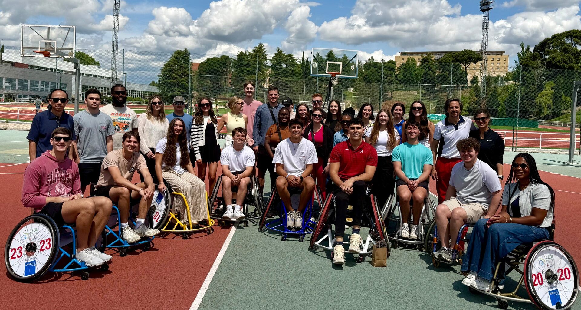 The group of Alabama students with several wheelchair basketball players