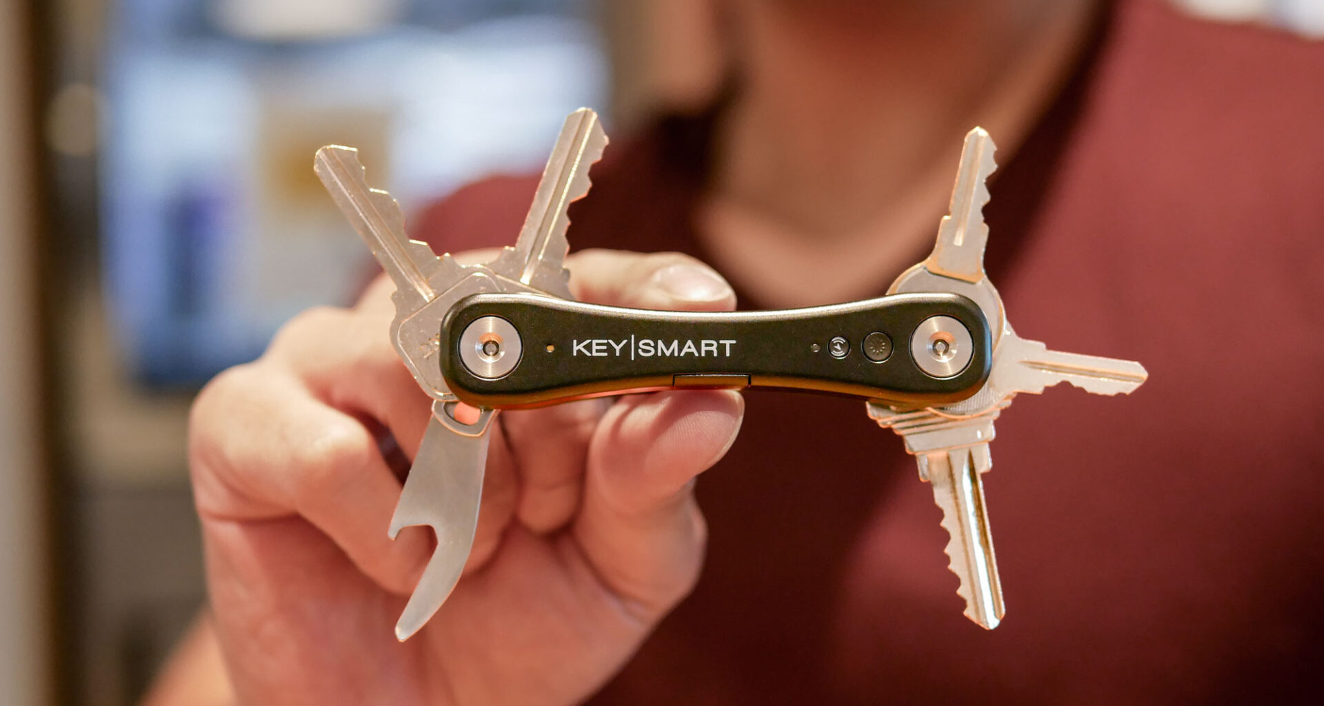 KeySmart iPro smart key tracker held in hand.