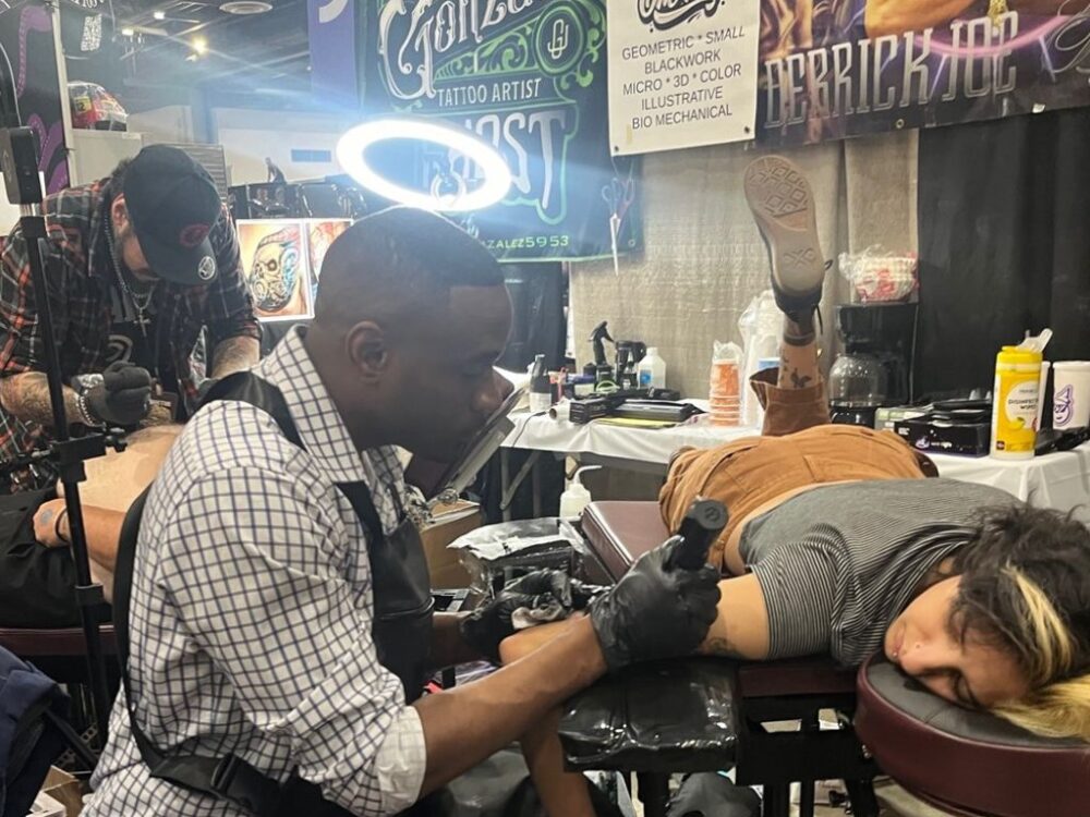 Tattoo artist Derrick Joe works on a client at the Villain Arts 7th Annual Houston Tattoo Arts Festival