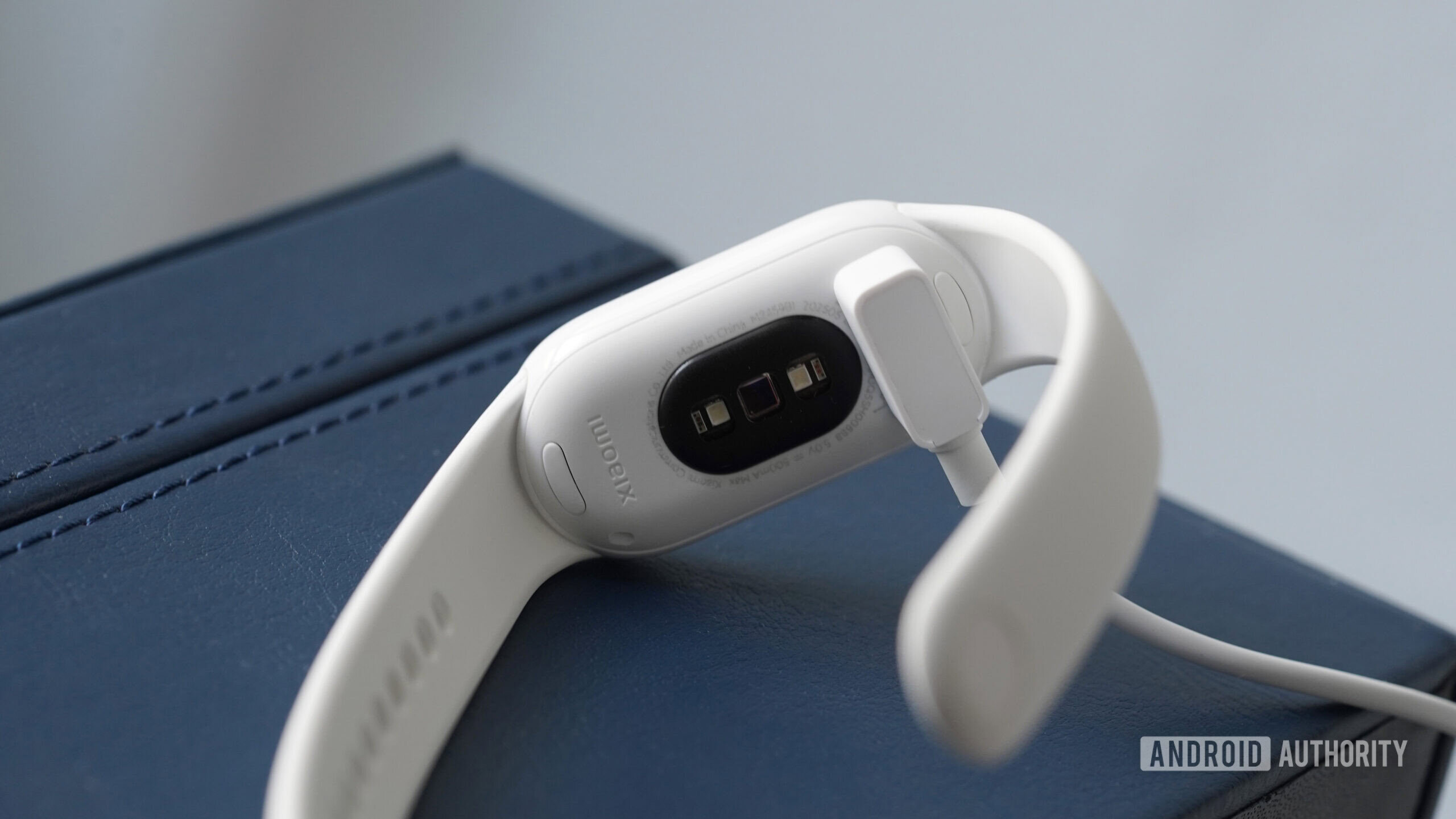 A Xiaomi Smart Band 10 charges on its proprietary cable.