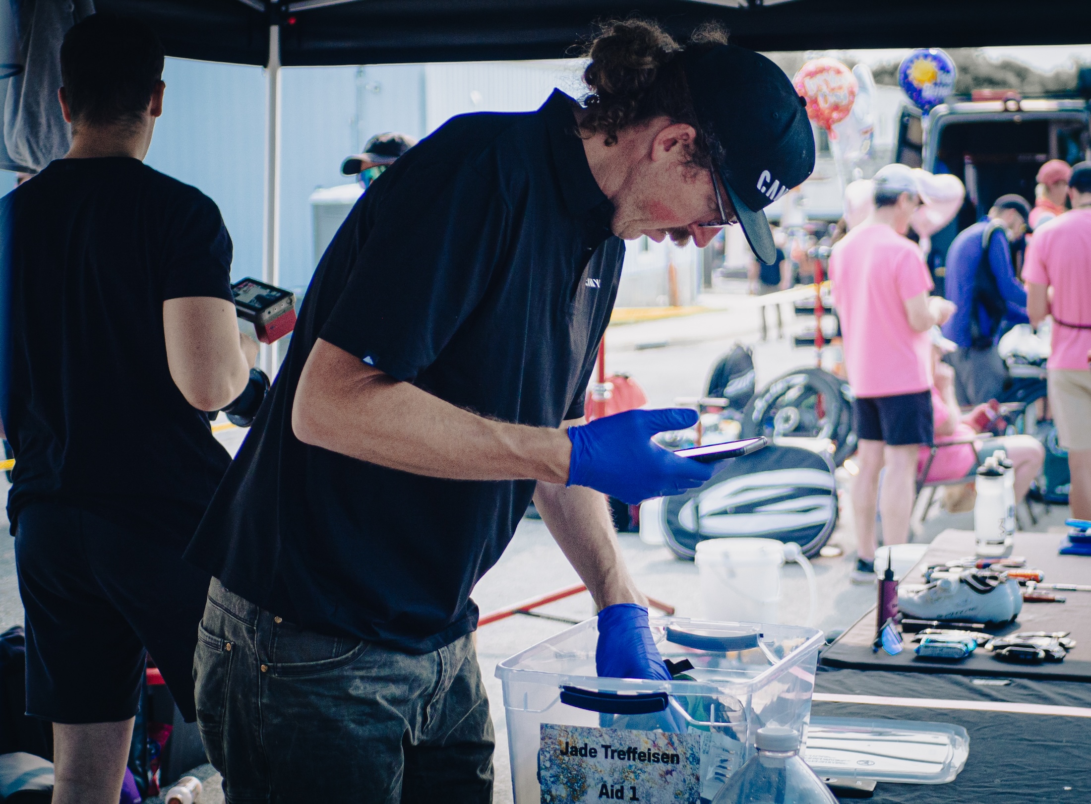 Big Tall Wayne prepares equipment for Canyon rider Jade Treffeisen, who swapped wheels at checlpoint #1 in Alma