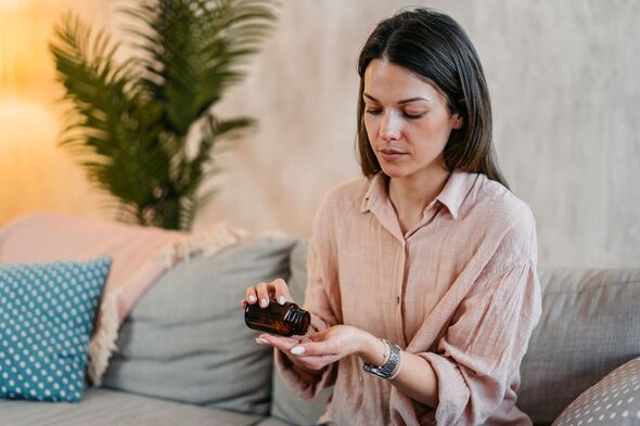 Young Woman Taking Medicine Pills