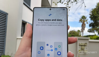 a smartphone held in a hand with a prompt to copy apps and data