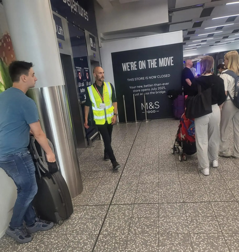 Photo of people in an airport with luggage, near a closed M&S Food store.