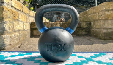 TRX Kettlebell outside in the sunshine, with a dog visible through the handle