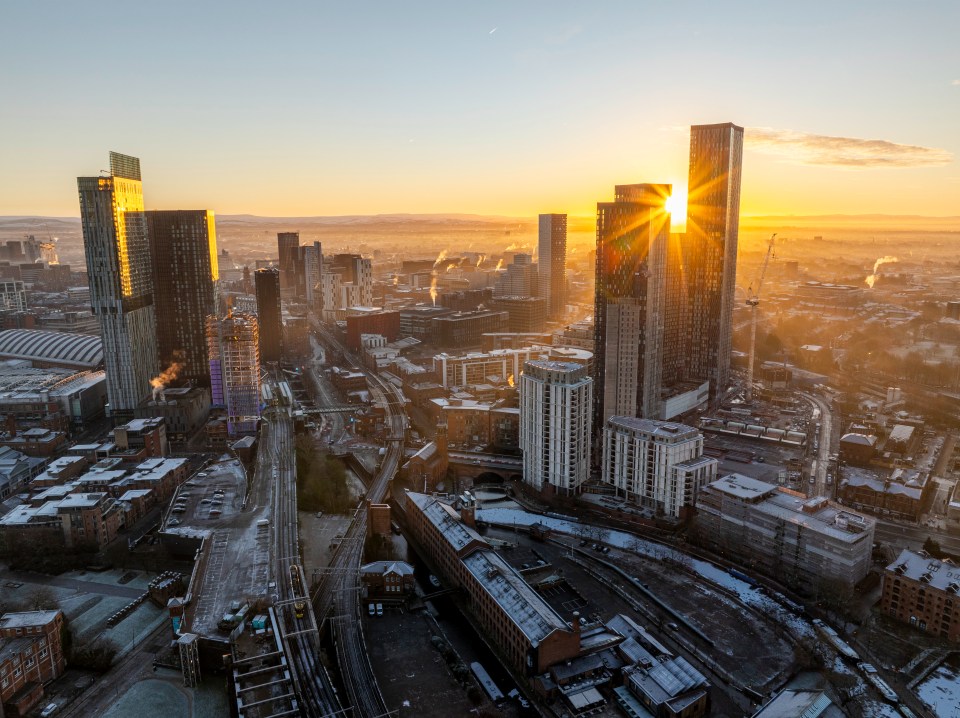 Aerial view of Manchester city skyline at sunrise with frost.