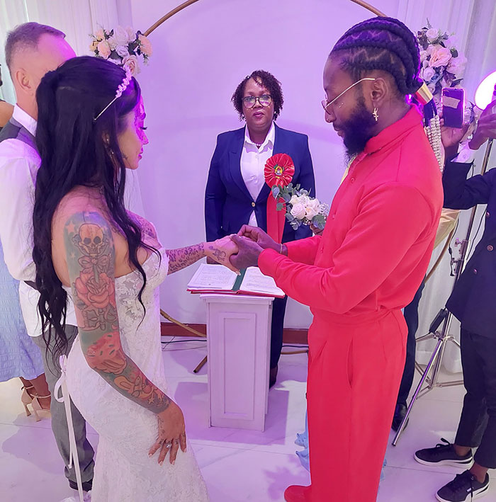 Couple exchanging rings at wedding ceremony with officiant present, highlighting plastic surgery ends in tragedy keywords.